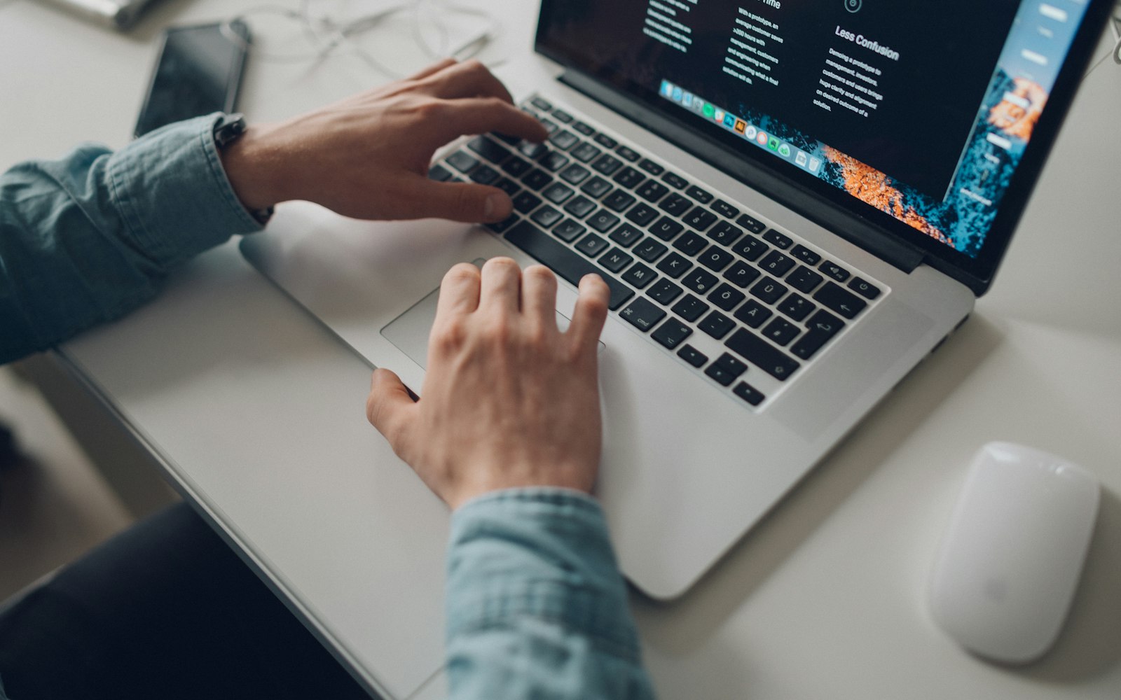 Small business owner reviewing their website on a laptop at a desk