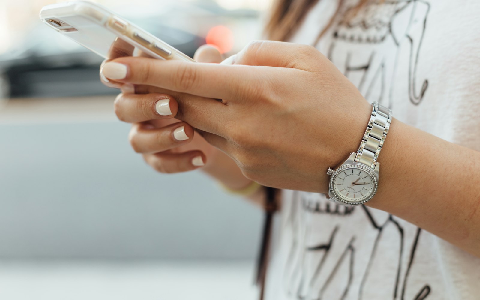 Person searching for a local business on their phone while walking through the city