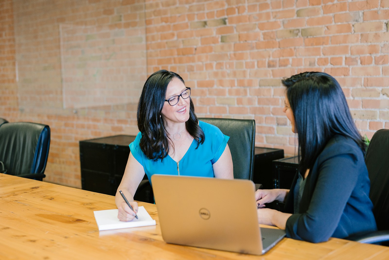 Small business owner meeting with a web designer to review a website proposal