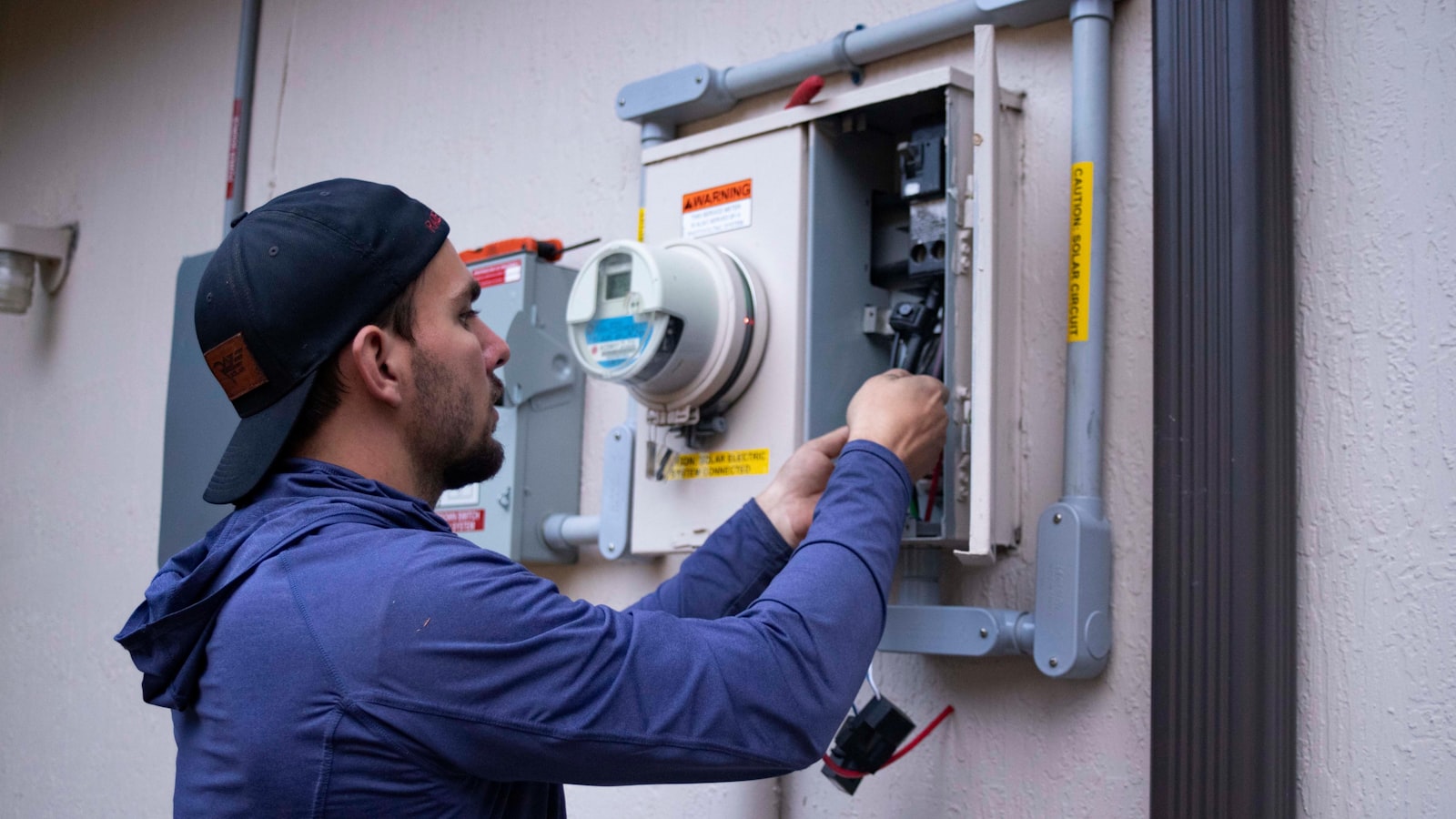 HVAC technician repairing a residential furnace during a service call